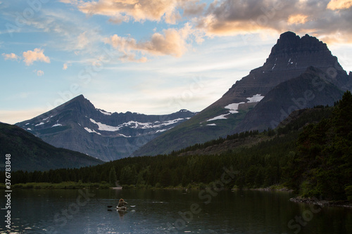 Rear view of man canoeing in Swiftcurrent Lake