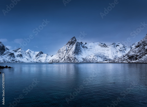 Mountains and reflections on water at night. Winter landscape. The sky with stars and clouds in motion. Nature as a background. Norway - travel © biletskiyevgeniy.com