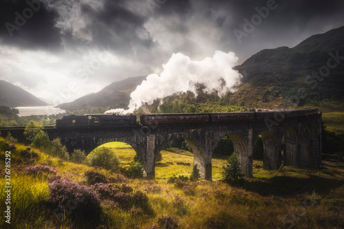 Jacobite steam train passing on Glenfinnan viaduct photo