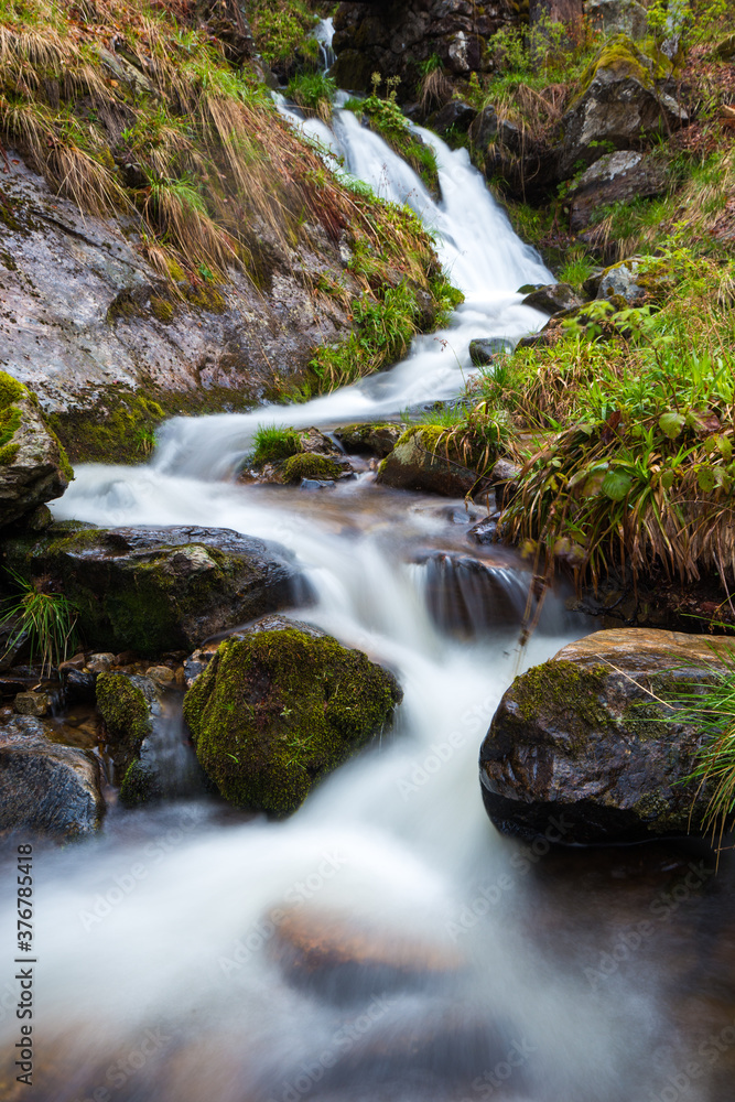Scenic view of waterfall flowing through rocks Scenic view of waterfall flowing through rocks