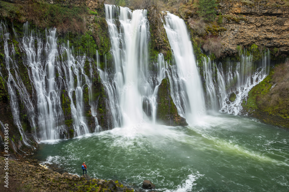 Hiker standing by Burney falls Hiker standing by Burney falls