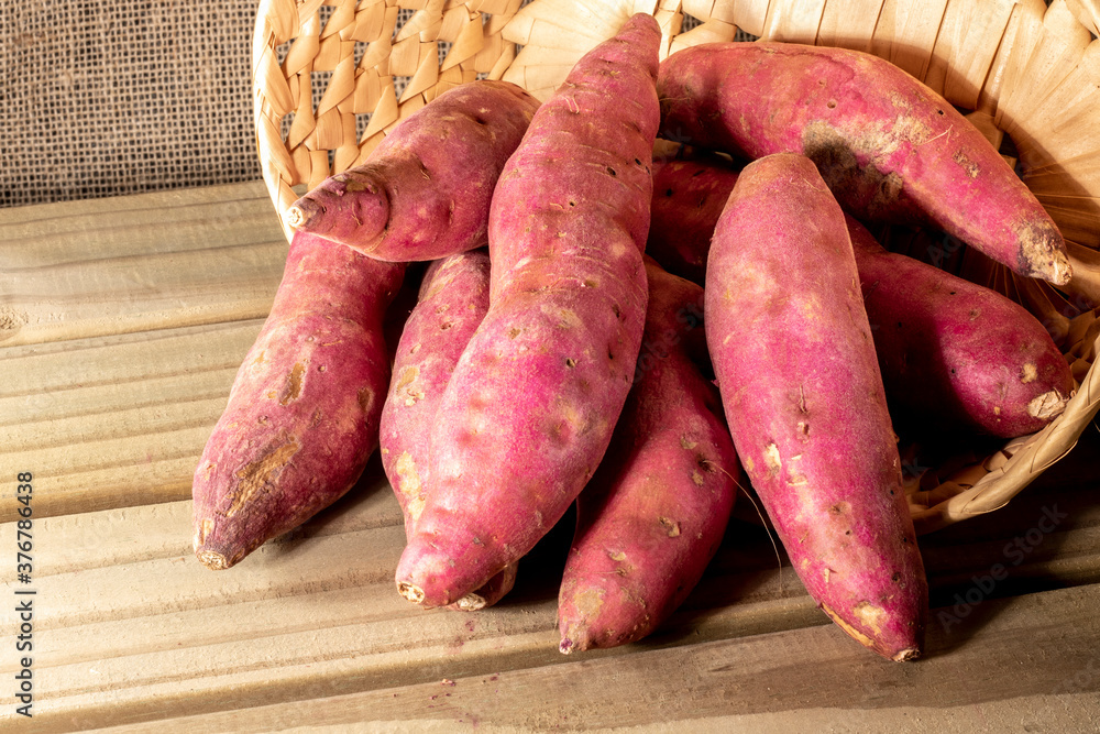 Sweet potato in basket on jute background in Brazil Sweet potato in basket on jute background in Brazil