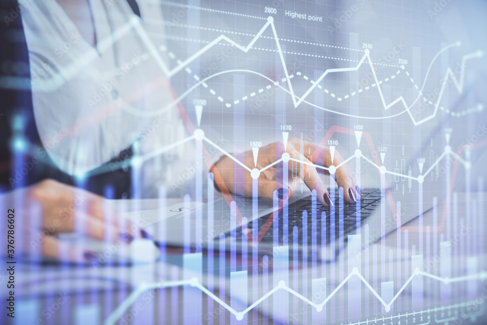 Double exposure of businesswoman hands typing on computer and forex graph hologram drawing. Financial analysis concept. Double exposure of businesswoman hands typing on computer and forex graph hologram drawing. Financial analysis concept.