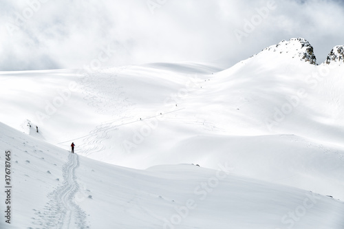 Scenic view of man skiing on mountain covered with snow photo