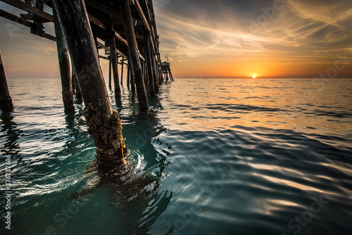 View of wooden pier in sea during sunset photo