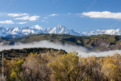 Snowcapped Sneffels Range with fog over Ridgeway photo