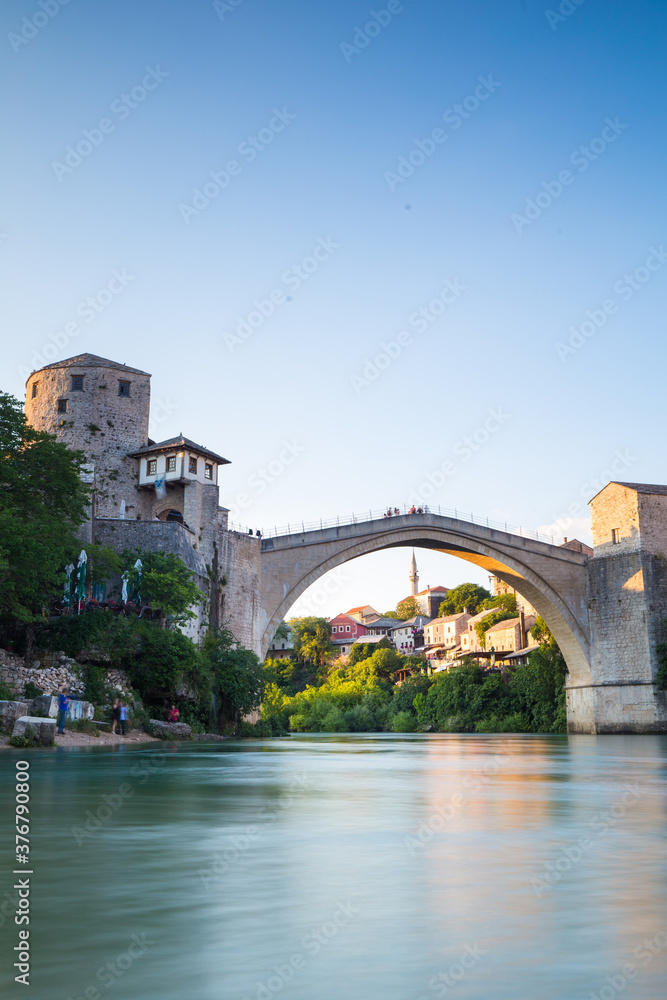 View of Mostar Bridge over river Neretva against sky View of Mostar Bridge over river Neretva against sky