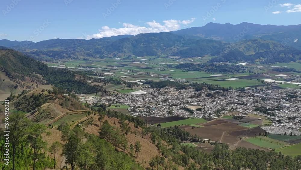 Astonishing daytime wide angle panning shot of a mountain town view in the Constanza Valley in Dominican Republic Astonishing daytime wide angle panning shot of a mountain town view in the Constanza Valley in Dominican Republic