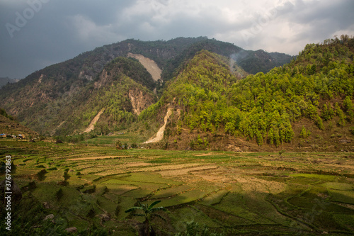 Scenic view of rural landscape with mountain in background photo