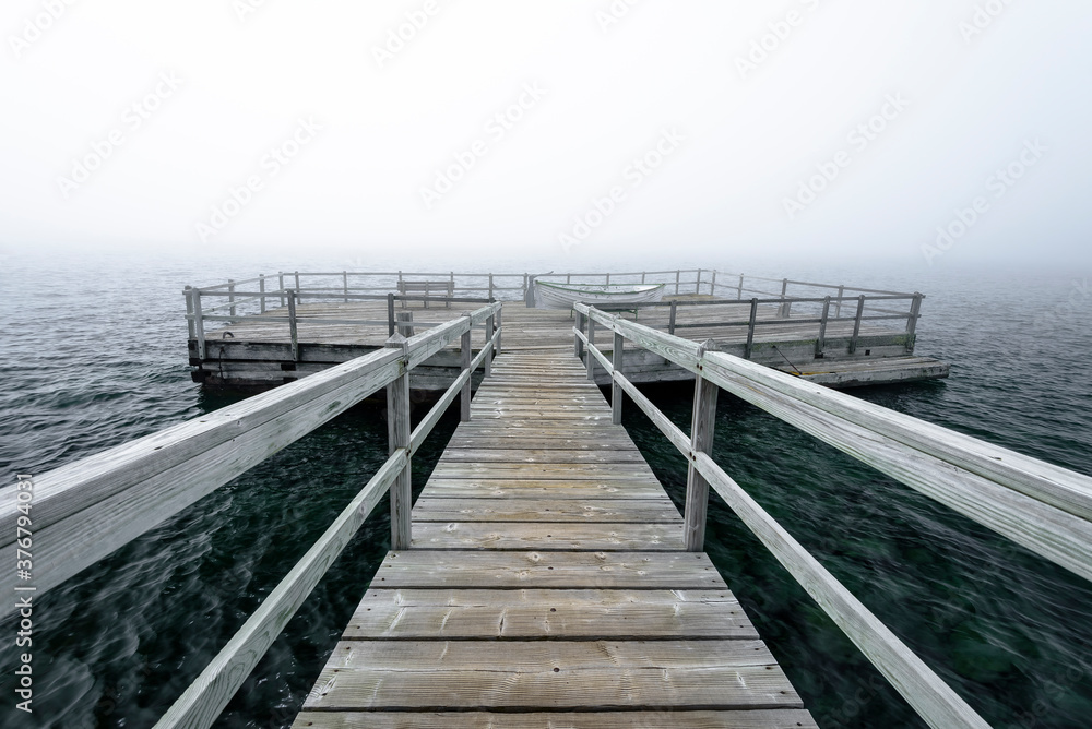 View of boardwalk leading to floating dock in sea View of boardwalk leading to floating dock in sea