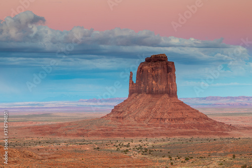 View of The Mitten buttes against cloudy sky photo