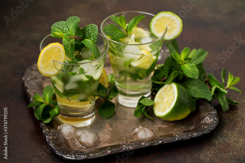 Glass of mojito, lime and mint martini on a vintage tray. Vintage retro style.