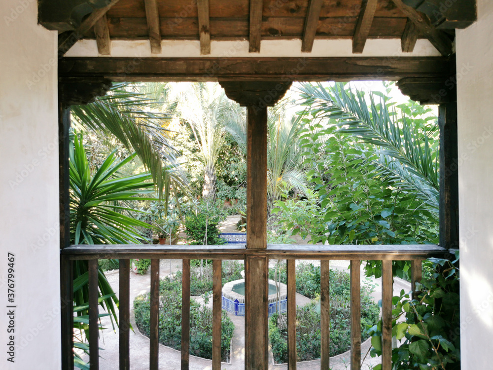 Fototapeta premium Balcony of the house with view of the tropical forest. Concept of travel and idyllic relax in tropics. Green background of palm trees.