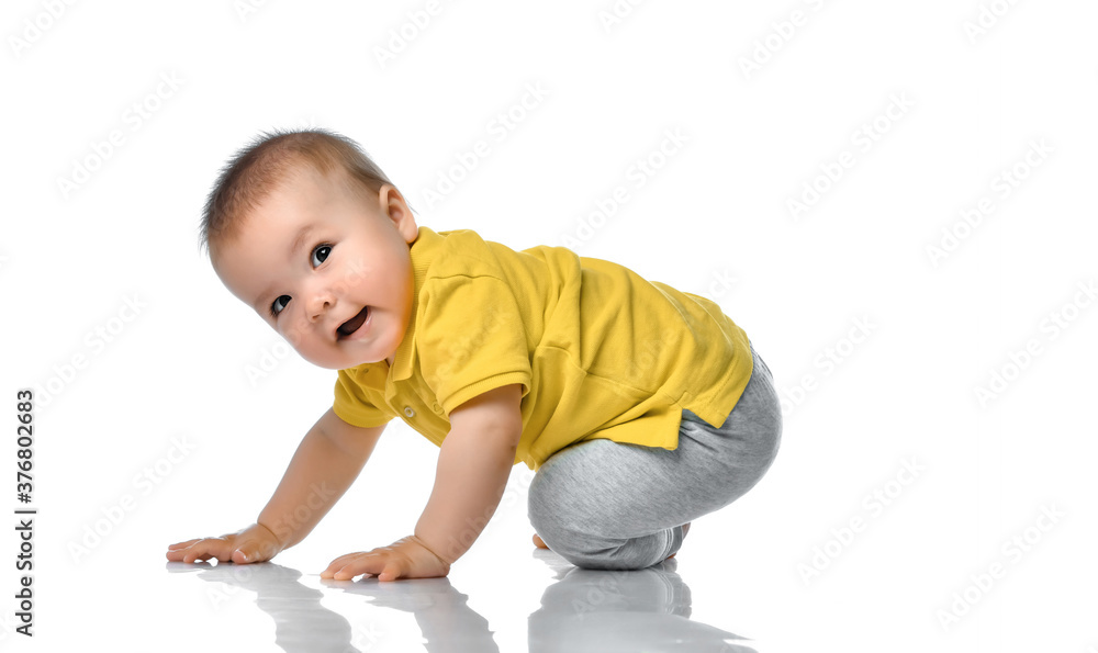 Little baby boy on floor looking over shoulder Little baby boy on floor looking over shoulder