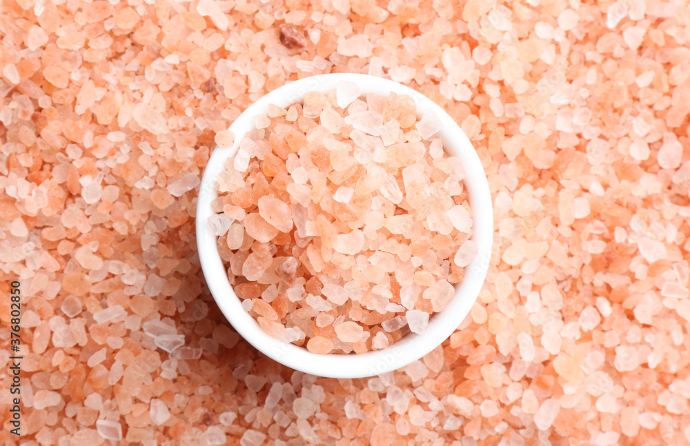 Pink himalayan salt and bowl as background, top view Pink himalayan salt and bowl as background, top view