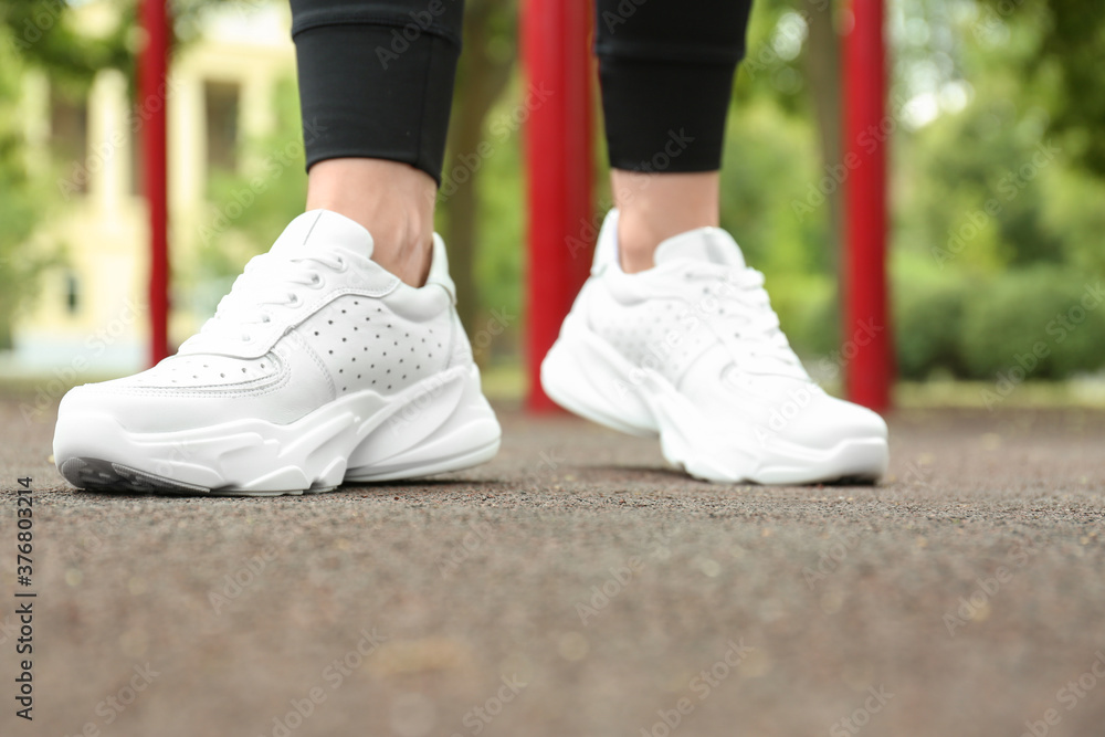 Woman in comfortable stylish sneakers outdoors, closeup