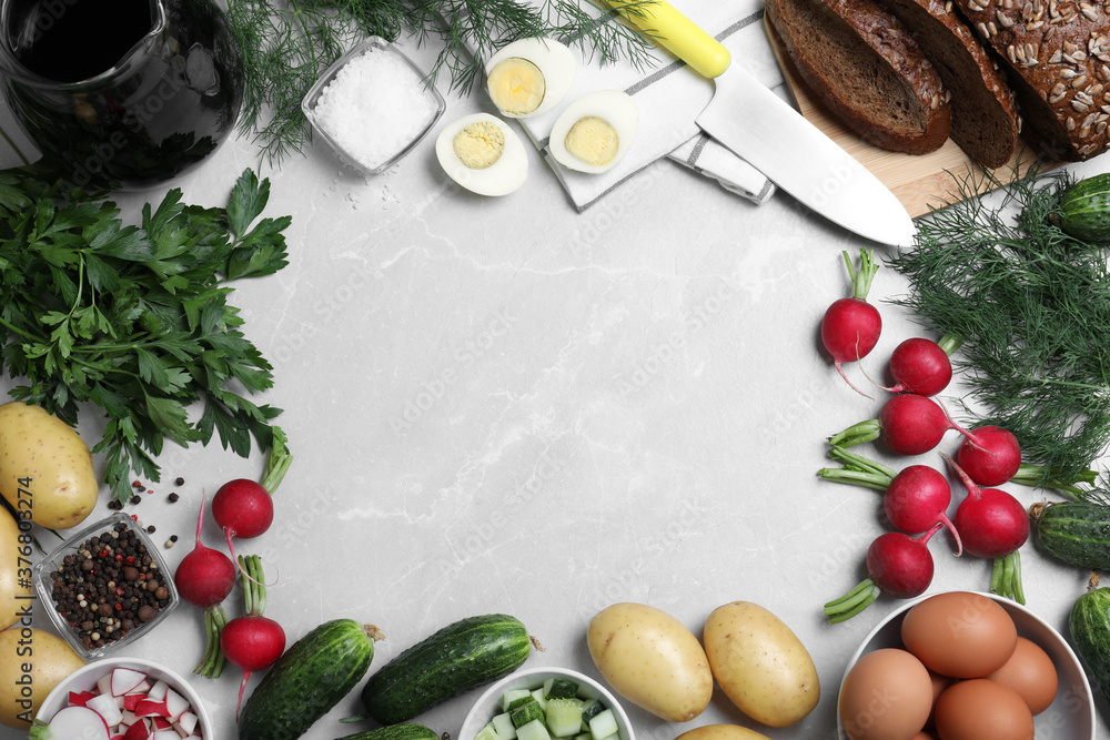 Frame of kvass and other okroshka ingredients on light grey table, flat lay with space for text. Traditional Russian summer soup Frame of kvass and other okroshka ingredients on light grey table, flat lay with space for text. Traditional Russian summer soup