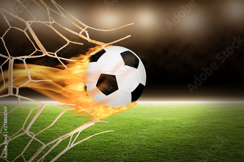 Flaming Soccer Ball Though Goal Net With Copy Space photo