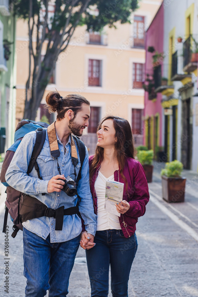 young latin couple of tourists on vacation with camera in Latin America
