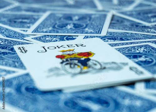 Face up card joker over a deck of cards