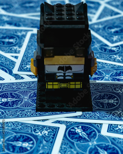 Little toy over a deck of cards