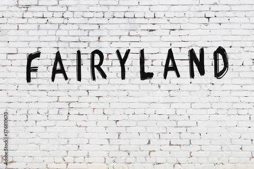 Photos Inscription fairyland painted on white brick wall