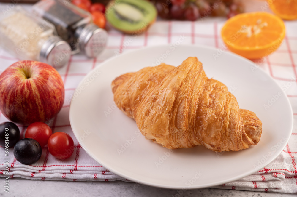 Croissant in a white plate.