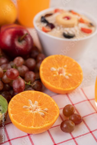 Orange cut in half with grapes and orange juice. © Johnstocker