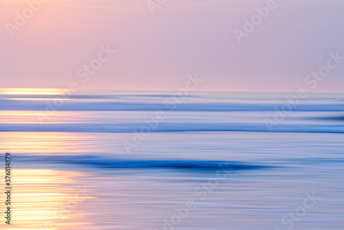 Abstract seascape with blur panning motion. Sunrise or sunset over sea  beautiful soft light blue and pink colors