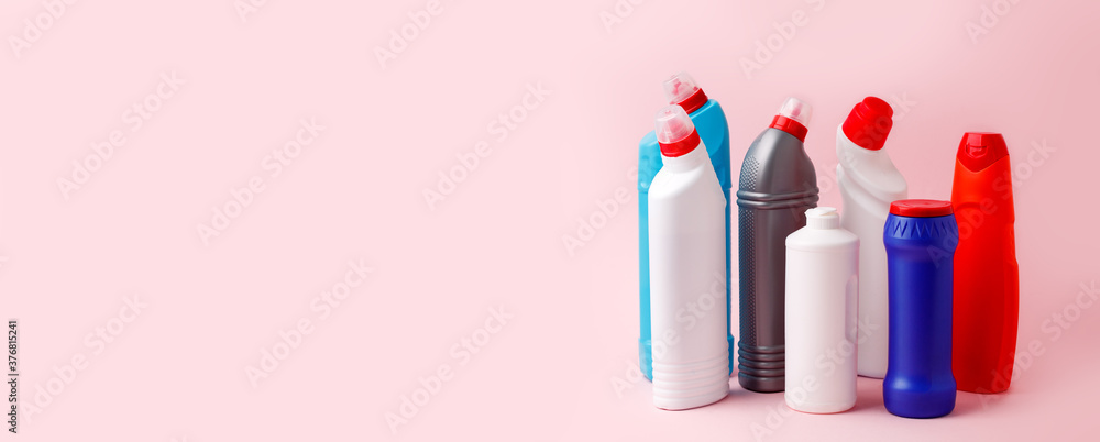 Cleaning products banner on pink background, copy space, concpet of house cleaning service, sanitize, antibacterial housework, bright bottles and washing tools, domestic chemical set Cleaning products banner on pink background, copy space, concpet of house cleaning service, sanitize, antibacterial housework, bright bottles and washing tools, domestic chemical set