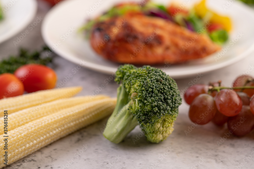 Broccoli, baby corn, grapes and tomatoes on white Broccoli, baby corn, grapes and tomatoes on white