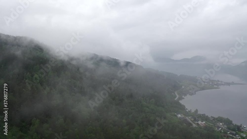 Flying through the clouds overlooking the Norwegian fjords and mountains photo