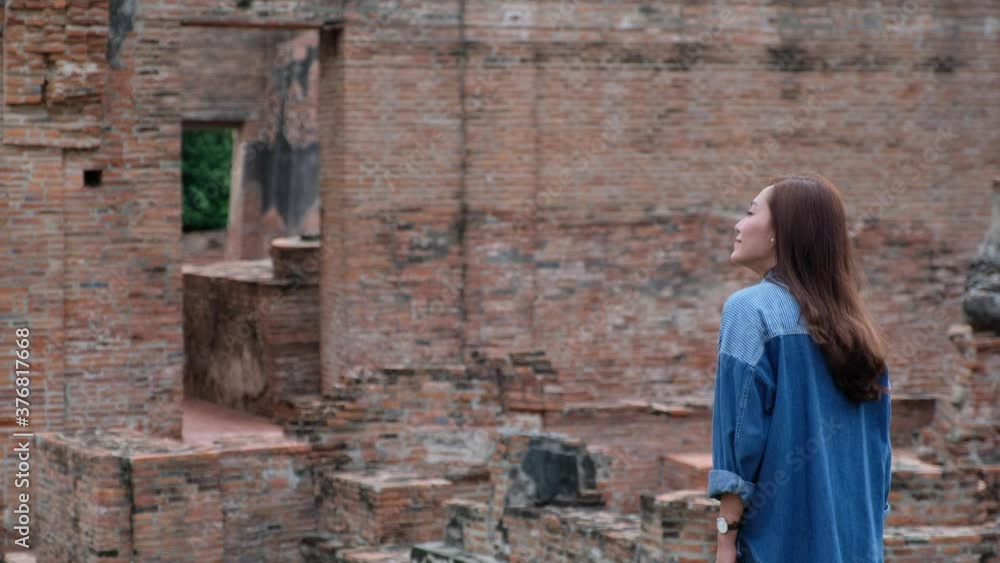 A woman traveling in ancient temple in Ayutthaya , Thailand A woman traveling in ancient temple in Ayutthaya , Thailand