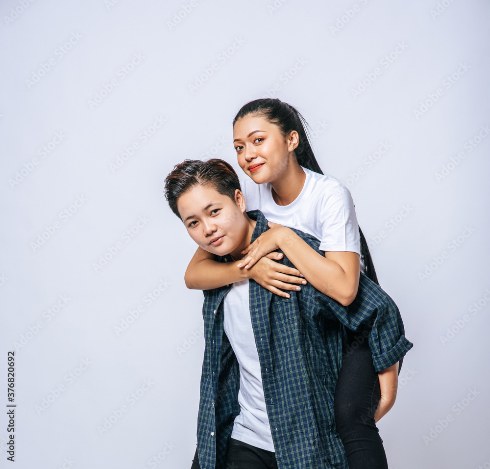 Two loving women wore striped shirts and rode their backs. Two loving women wore striped shirts and rode their backs.