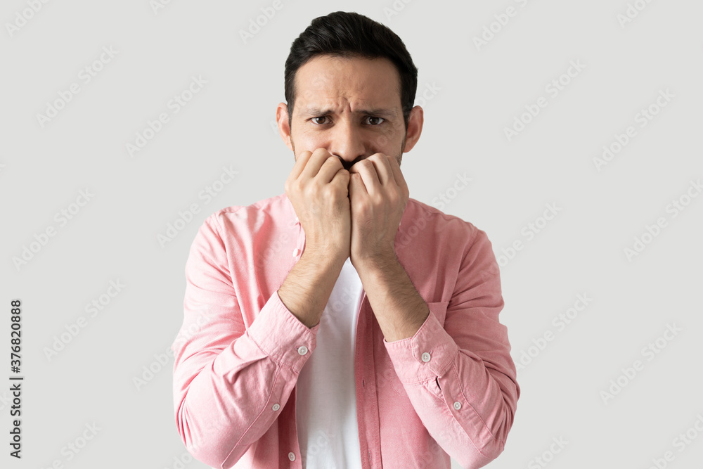Young guy looking nervous in a studio Young guy looking nervous in a studio