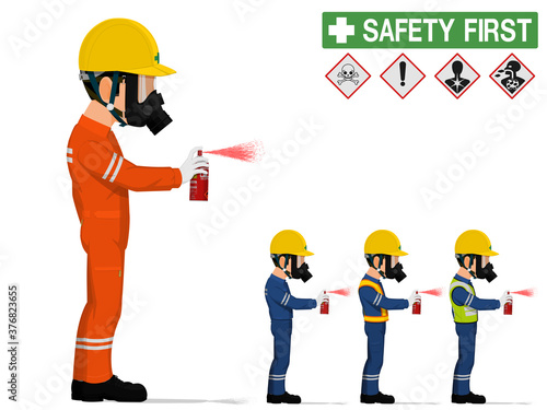 An industrial worker with respirator is spraying color