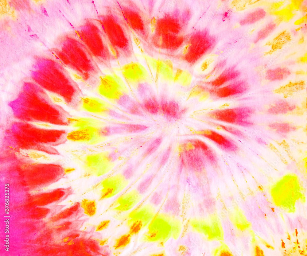 Spiral tie dye texture wallpaper background in red pink and yellow. Tie