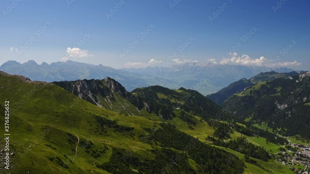 Slow Pan movement right over the lush green mountain in the Alps of Liechtenstein, aerial view over the Valley of Malbun Slow Pan movement right over the lush green mountain in the Alps of Liechtenstein, aerial view over the Valley of Malbun