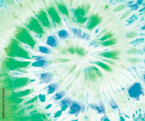 Spiral tie dye pattern in green and blue. 