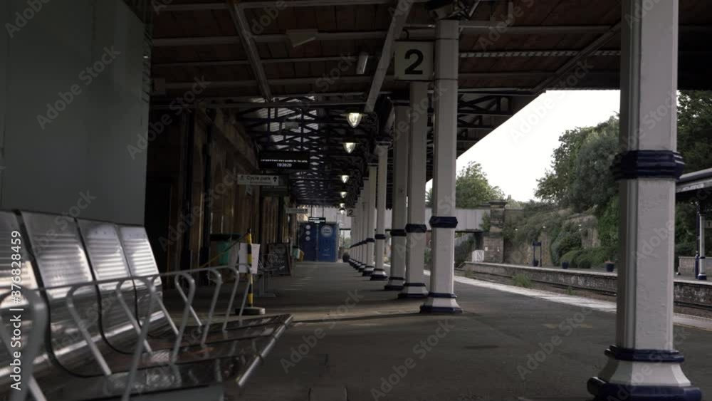 Walk through empty train station platform wide shot Walk through empty train station platform wide shot