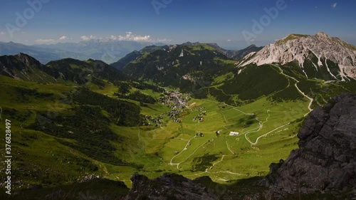 Panoramic view from a mountain top in the Alps. Zoom in the lushgreen Valley of Malbun in Liechtenstein in summer. photo