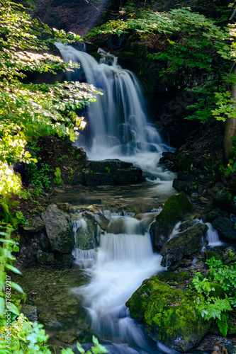 Fototapeta Naklejka Na Ścianę i Meble -  Larger waterfall on the river in the forest.