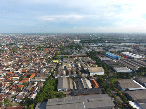 Aerial view of the SIER (Surabaya Industrial Estate Rungkut) industrial area amidst the densely populated city of Surabaya, Indonesia photo