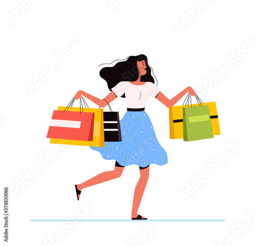 Young shopping woman holds packages from the store in her hands and jumps happily. The concept of a successful purchase and the joy of discounts