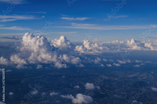 cityscape view from airplane with cloudy blue sky above  photo may has some noise