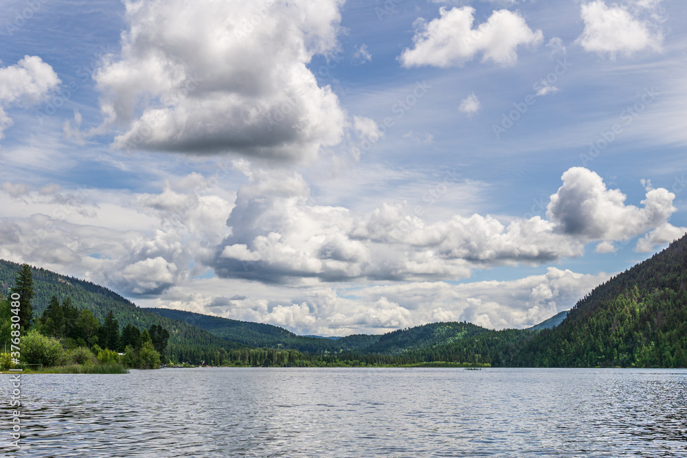 Paul Lake Summer time with green mountains and white clouds british columbia canada.