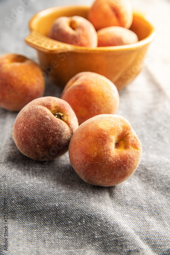 Fresh ripe bio peaches on tablecloth.