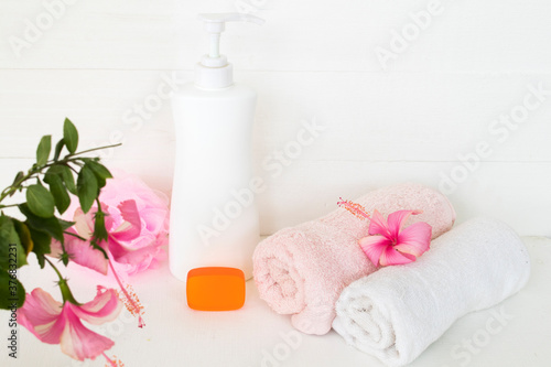 herbal liquid soap health care for body skin and soap for skin face with terry cloth  pink flower hibiscus arrangement flat lay style on background white 