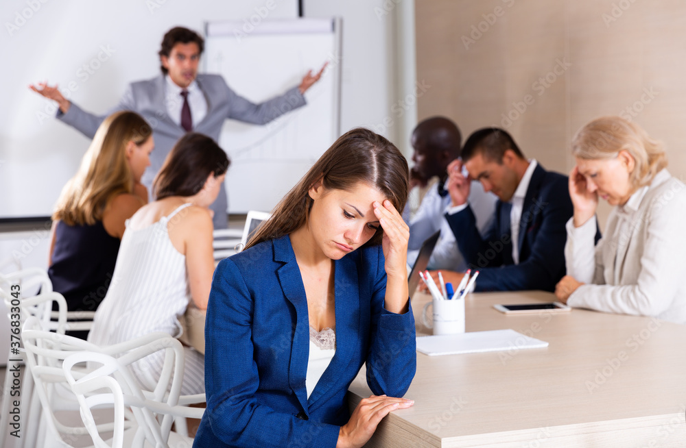 Fototapeta premium Portrait of sad and tired business woman on meeting in office