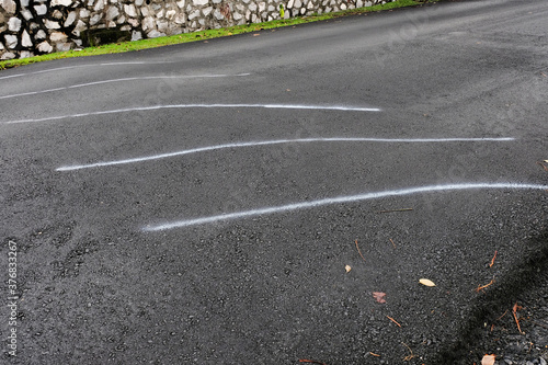 Canvas Print White stripes being sprayed on a speed bump after being tarred, acting as a quick and easy interim solution to warn road users